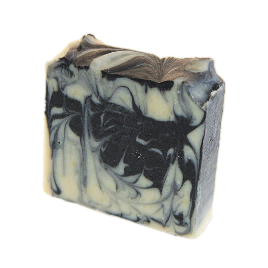 A black and white Goat's Milk & Charcoal Face Soap bar on a white background by ajp-test.